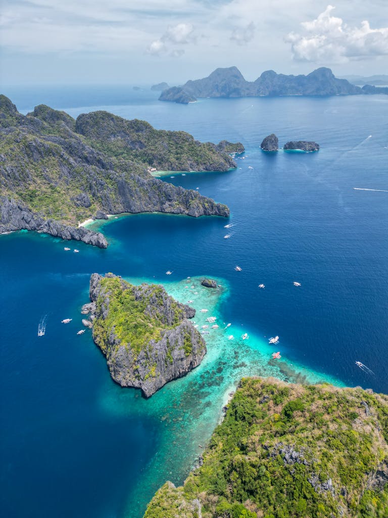 A breathtaking drone shot capturing the lush islands surrounded by crystal blue waters in Palawan, Philippines.