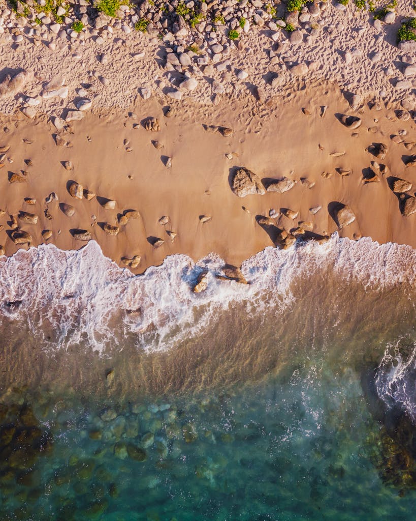 A stunning aerial shot of the sandy beach and waves in Porto do Son, Galicia, Spain.