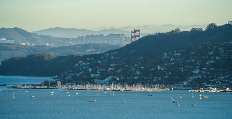 Scenic view of Golden Gate Bridge over San Francisco Bay with yachts in the foreground.