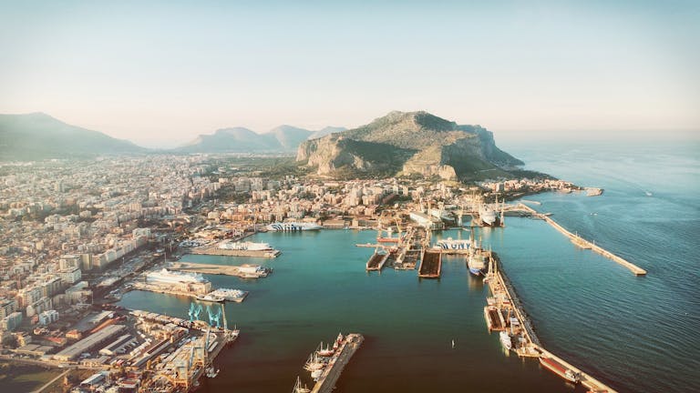 Stunning aerial view of Palermo's harbor with Monte Pellegrino in Sicily, Italy, under daylight.