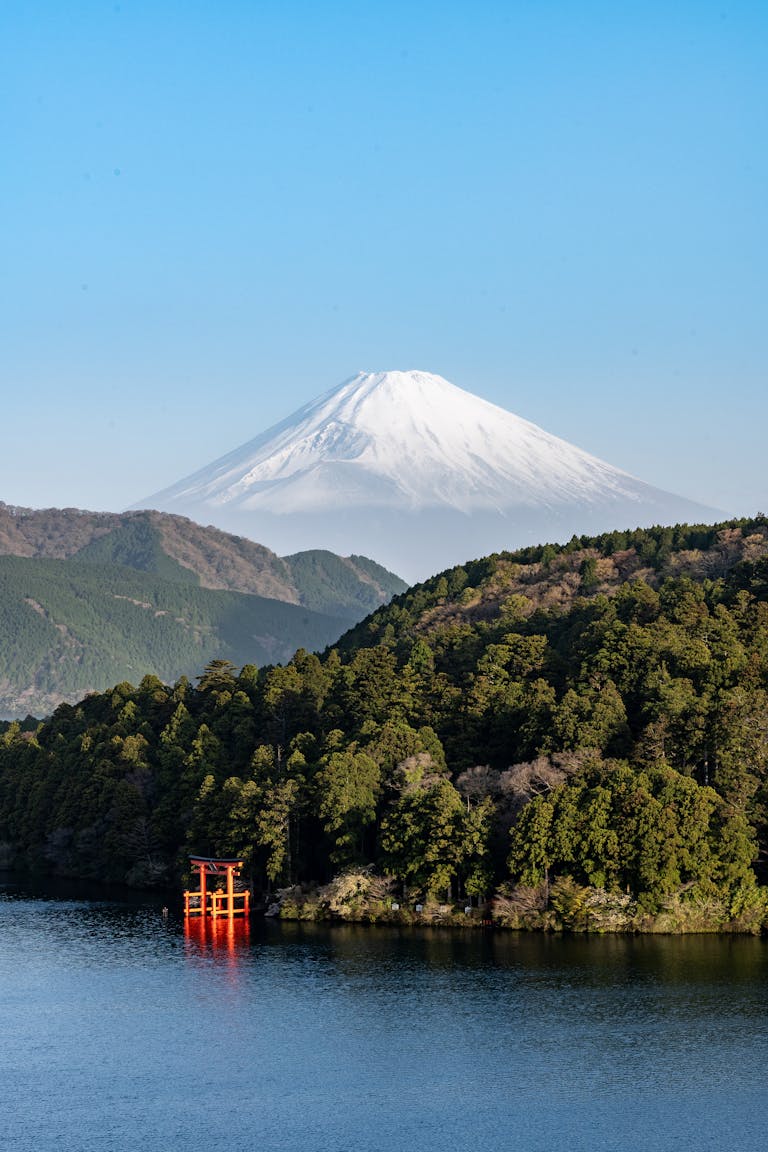 Stunning view of Mount Fuji with a red torii gate on Lake Ashi in Hakone, Japan.