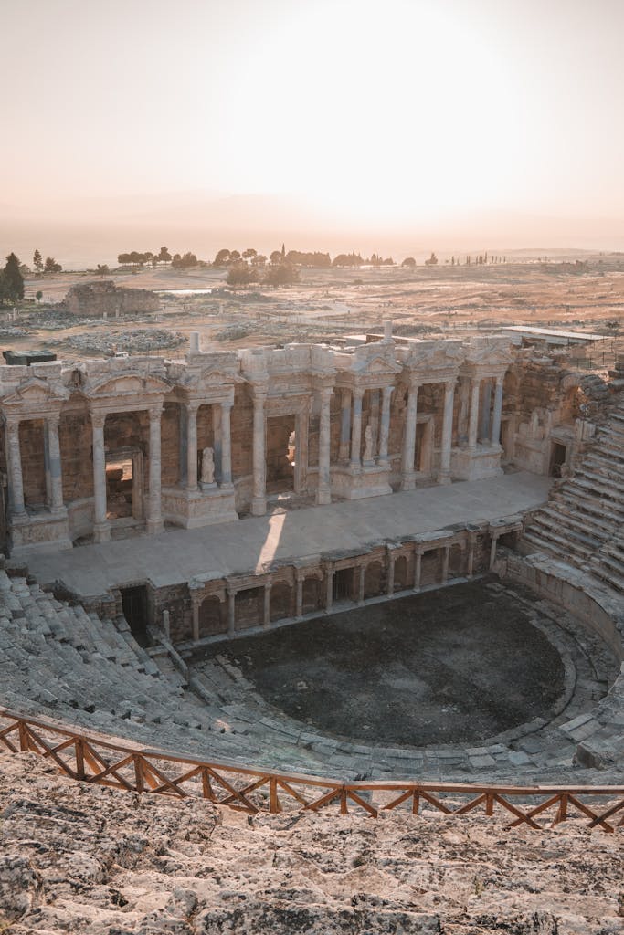 Sunlit view of the ancient Roman amphitheater in Pamukkale, Turkey, highlighting its historic architecture.