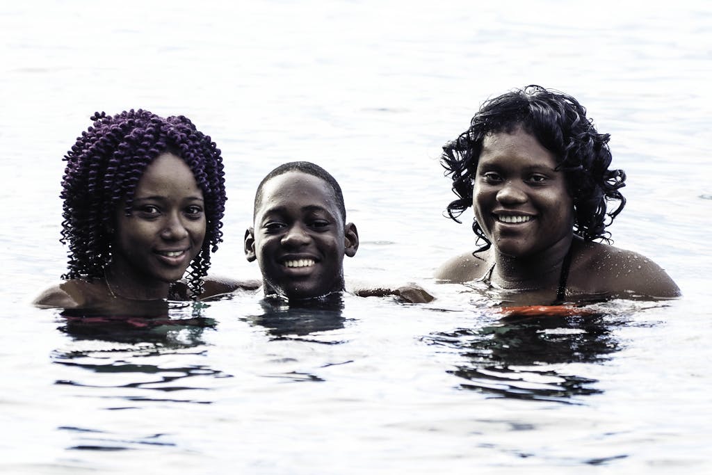 Three friends enjoying a refreshing swim in Buccament, St. Vincent under the sun.