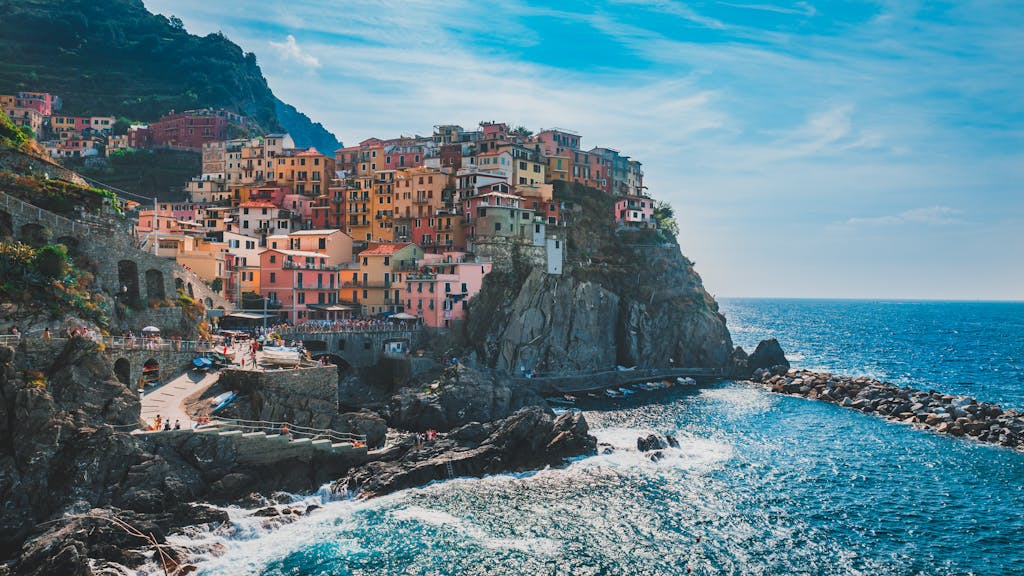 Vibrant houses on a cliff overlooking the ocean in Cinque Terre, Italy. Stunning coastal scenery.